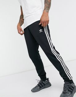 adicolor three stripe skinny sweatpants in black