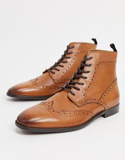 brogue boots in tan leather with natural sole