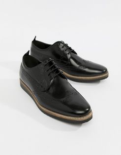 brogue shoes in black leather with wedge sole