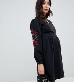 ASOS DESIGN Maternity denim smock dress in washed black with embroidery