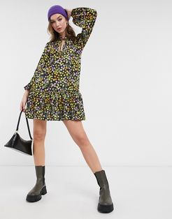 mini smock dress with pep hem and tie neck detail in black based floral