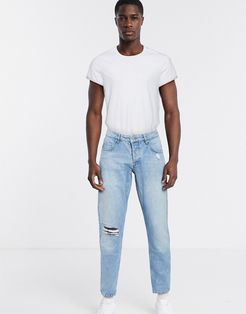 slim jeans in mid wash blue with knee rips