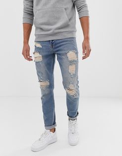 stretch slim jeans in vintage light wash blue with heavy rips-Blues