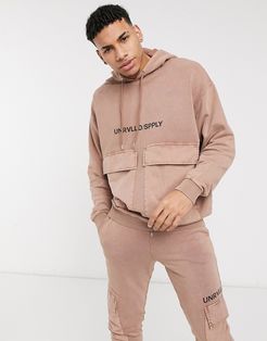 ASOS Unrvlld Spply coordinating oversized hoodie in washed tan with printed logo-Brown