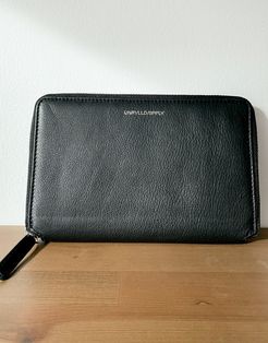 ASOS Unrvlld Spply travel wallet in black leather with coin pouch and embossed branding