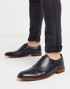 cast brogues in black leather