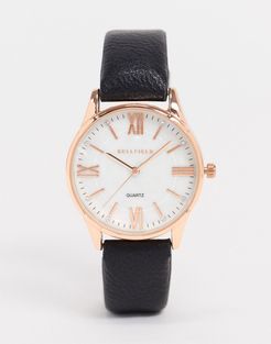 watch with black strap and rose gold dial