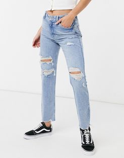slim jeans with distressed hem in light blue-Blues