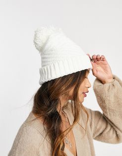 textured knitted hat with yarn pom in cream