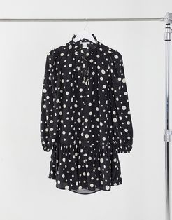 mini smock dress with tie neck and peplum hem in polkadots-Black