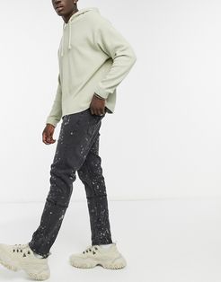 spliced jeans with paint splatter effect in black