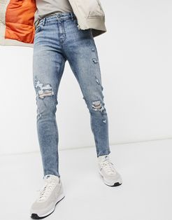 skinny jeans with rips in mid blue wash-Blues