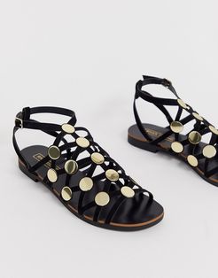 caged flat sandal with studs in black