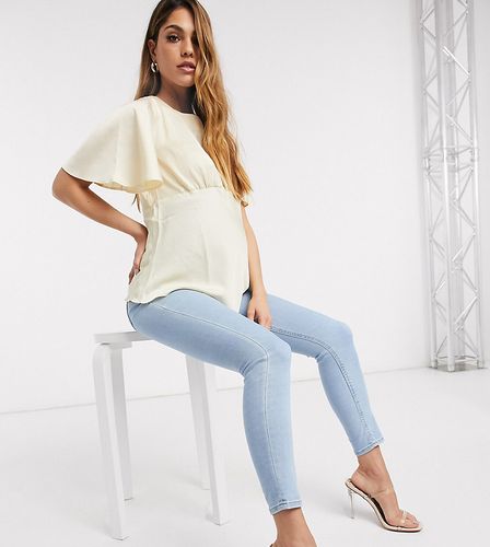 ASOS DESIGN Maternity high rise ridley 'skinny' jeans in bright lightwash blue with over bump waistband-Blues