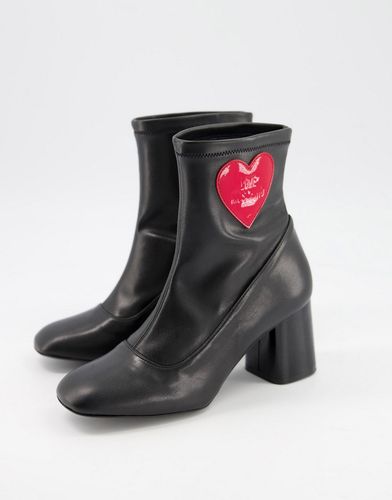 heeled sock boots with heart in black
